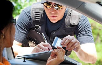Police officer writing out a traffic citation